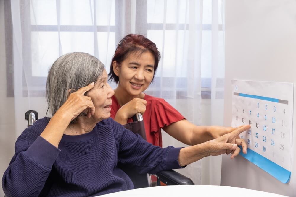 Nurse helps patient in senior living community focusing on memory care