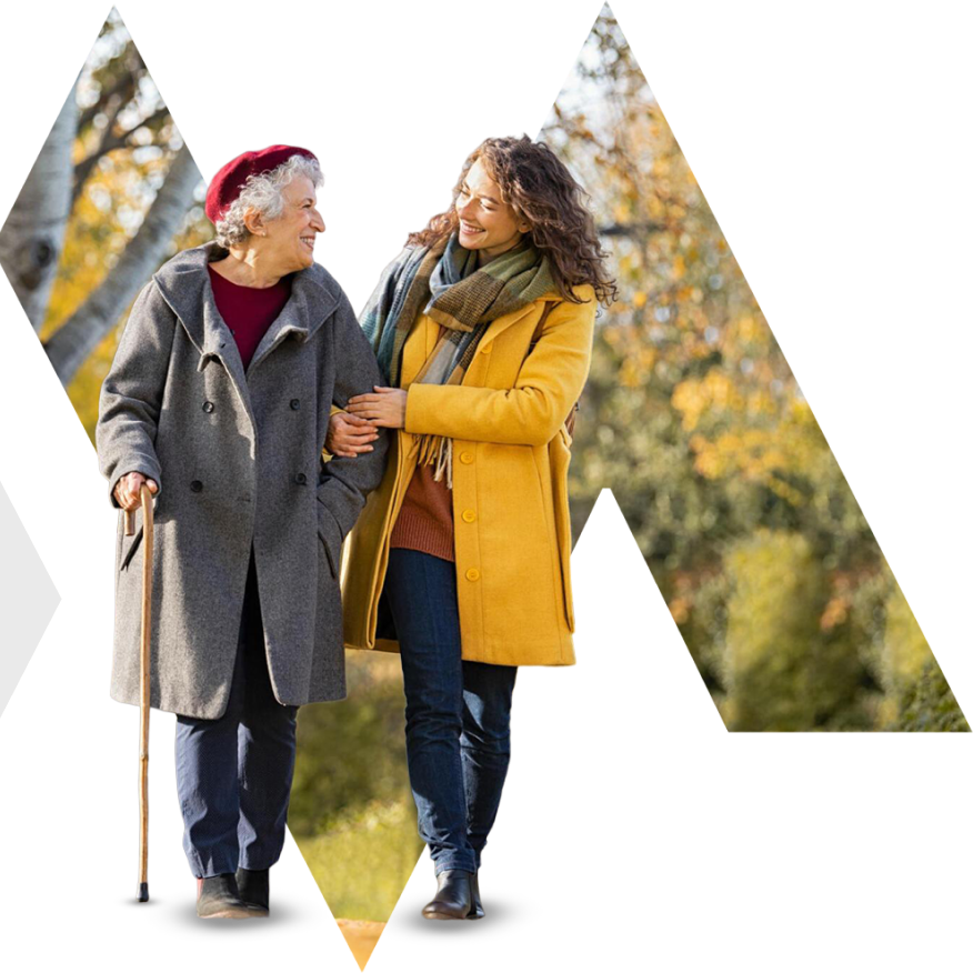 Shared moments of joy in our retirement home community, with younger caregivers offering support to seniors using walking canes during a leisurely stroll through our park.