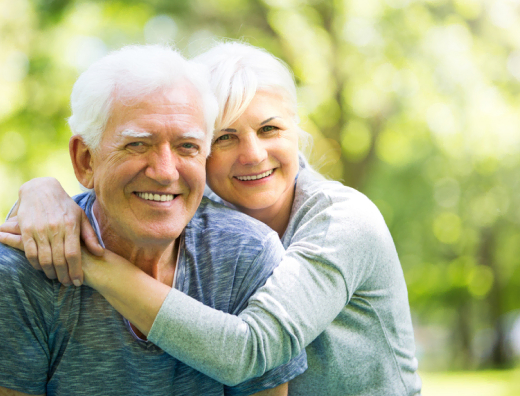 Your golden years at Mira Vie Retirement Community, where senior couples share joyful moments and warm embraces in the great outdoors.