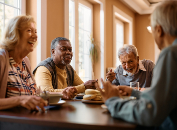 Lively conversations and laughter with fellow seniors at our Retirement Community dining table.