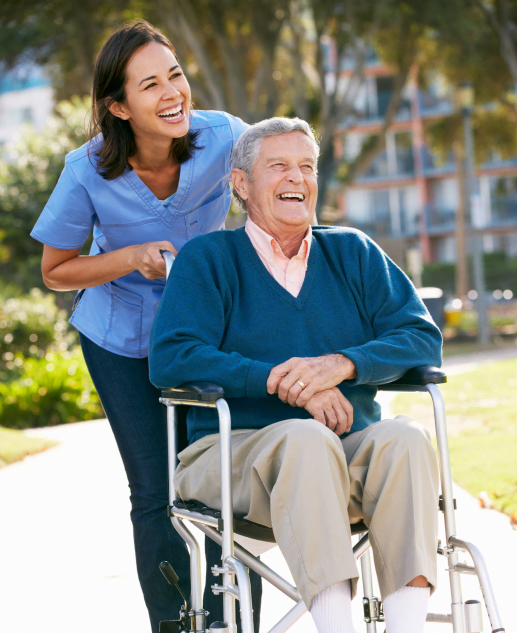 Smiling healthcare provider with a senior resident outdoors at Mira Vie at Brick retirement community.