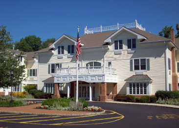 Senior living at its best in our two-story retirement community, complete with a central balcony and proudly displaying an American flag. Our landscaped entrance offers a warm welcome to all residents. For more information about Mira Vie Retirement Home, please get in touch with us.