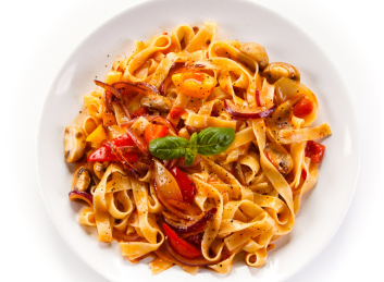 Savor a plate of pasta with tomatoes, mushrooms, and basil at Mira Vie at Brick Retirement Community.