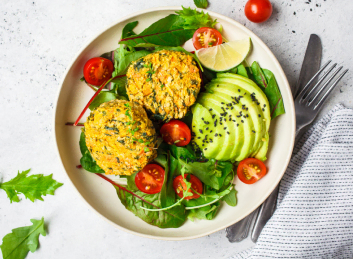 A healthful meal of quinoa patties accompanied by avocado slices, cherry tomatoes, and mixed greens at Mira Vie at Brick, an exemplary retirement home community.