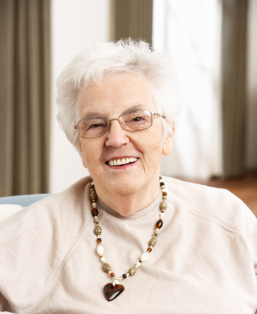 Cheerful senior woman in beige sweater and beaded necklace enjoys life at Mira Vie Fanwood Retirement Community.