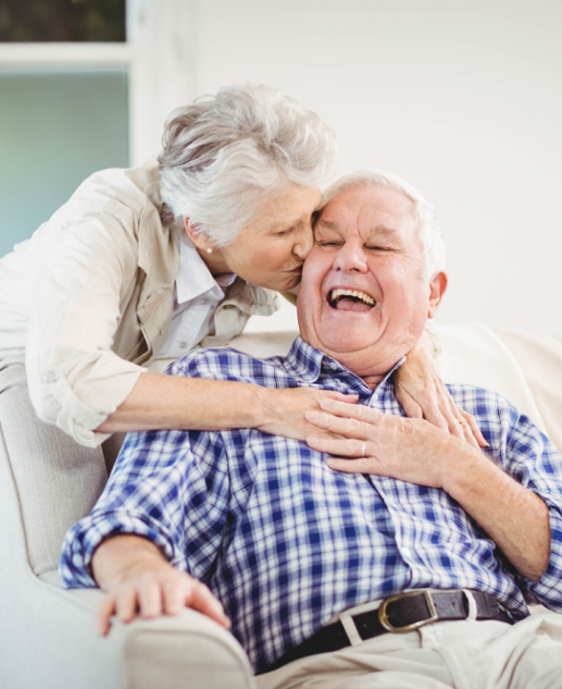 Senior couple sharing a loving moment at Mira Vie at Brick retirement community.