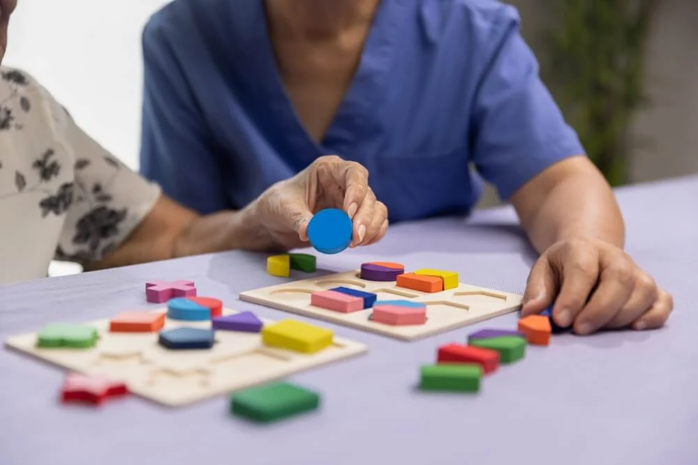 Elderly residents at our retirement community brain-boosting games using vibrant shapes and blocks for cognitive stimulation.