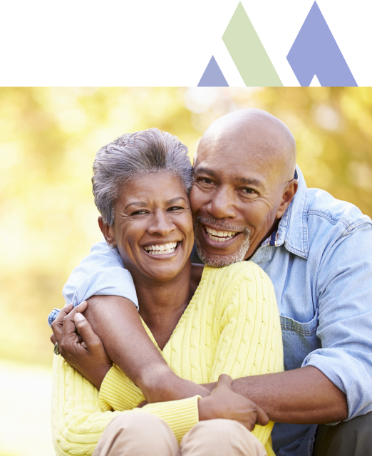 Delighted couple enjoying a sunny day with warm embraces at Mira Vie at Montville, an idyllic retirement community.