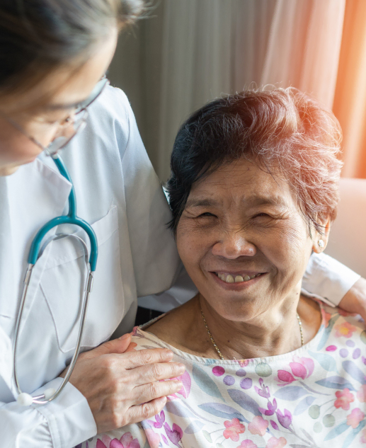 Healthcare professional providing comfort to a joyful senior resident at Mira Vie in Montville retirement home community.