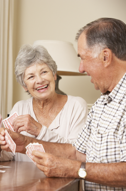 Blissful moments with your partner in our retirement community, engaging in joyful activities like playing cards together.