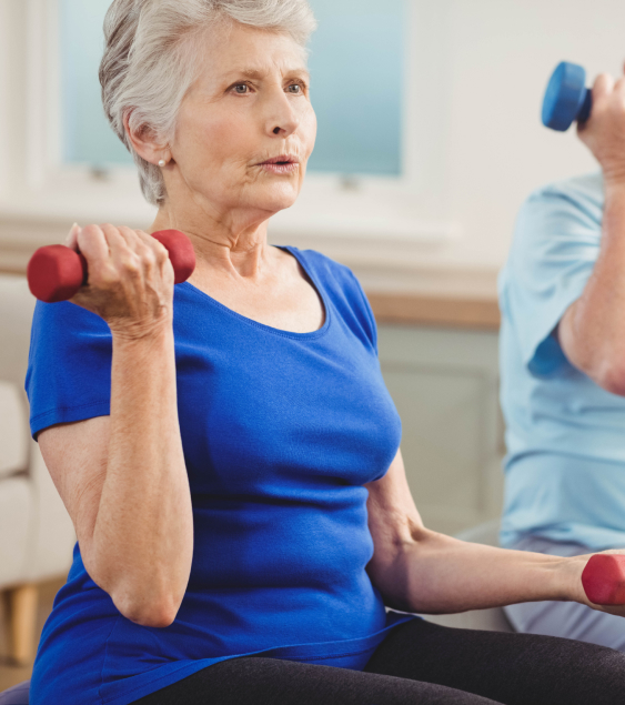 Active elder woman enhancing wellness in our retirement community through dumbbell exercises.