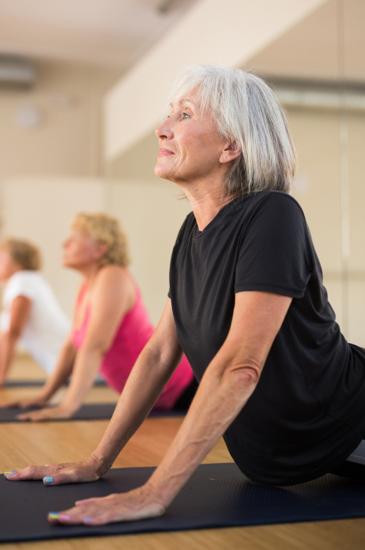 Elderly ladies participating in a health-focused yoga session in our retirement community.