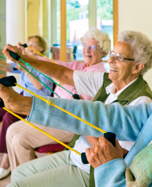 Join our active community of senior women enjoying Mira Vie resistance band exercise classes at Brick Retirement Home, always meeting with a smile.