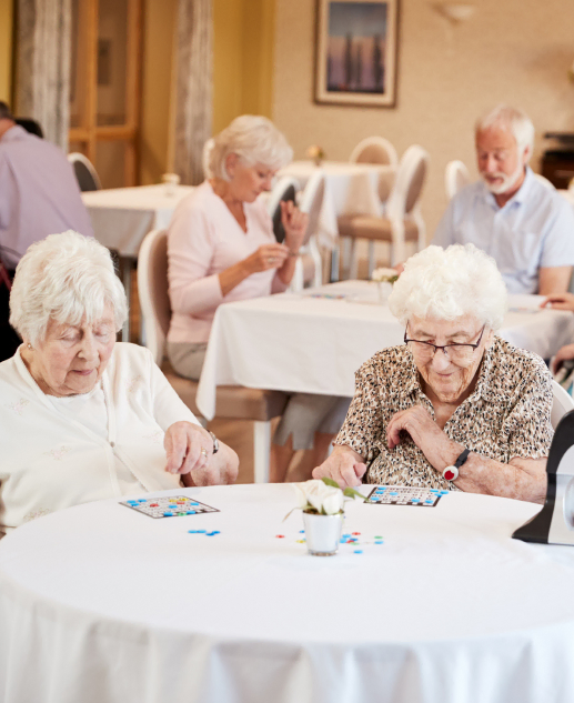 Elderly residents a lively game of bingo at the picturesque Mira Vie at Warren retirement home, embodying an active and vibrant senior living community.