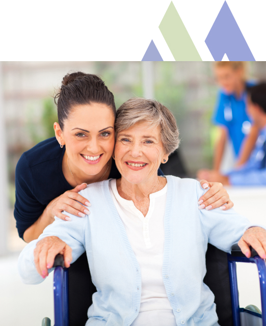 Cheerful younger woman shares a close moment with an elderly lady at the wheelchair-friendly retirement home, Mira Vie in West Milford.