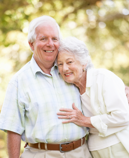 Elderly couple happily embracing outdoors at Mira Vie Retirement Community in West Milford.