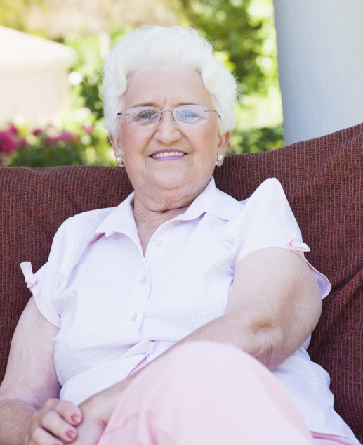 Smiling elderly woman enjoys outdoor relaxation at Mira Vie at West Milford retirement home.