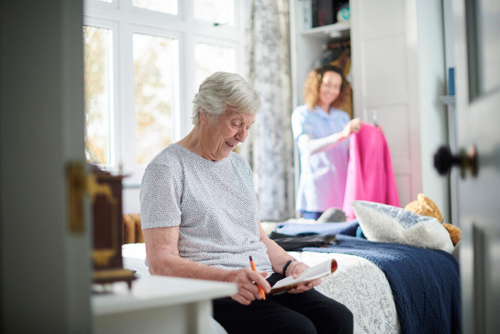 A senior woman doing a puzzl