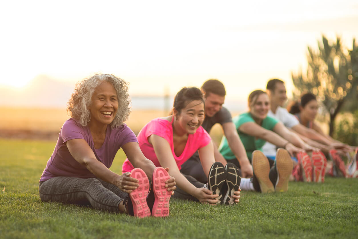 A senior woman at an outdoor fitness class