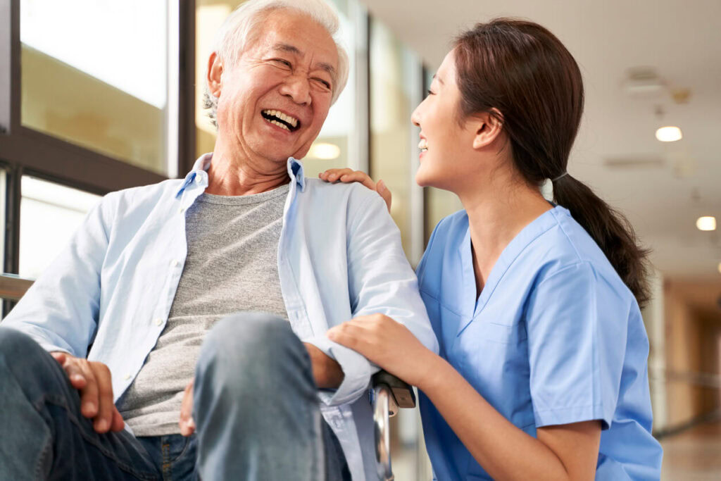 A caregiver with a nursing home resident in a wheelchair