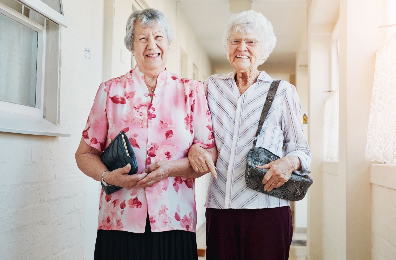 A pair of senior friends wearing comfortable stylish outfits