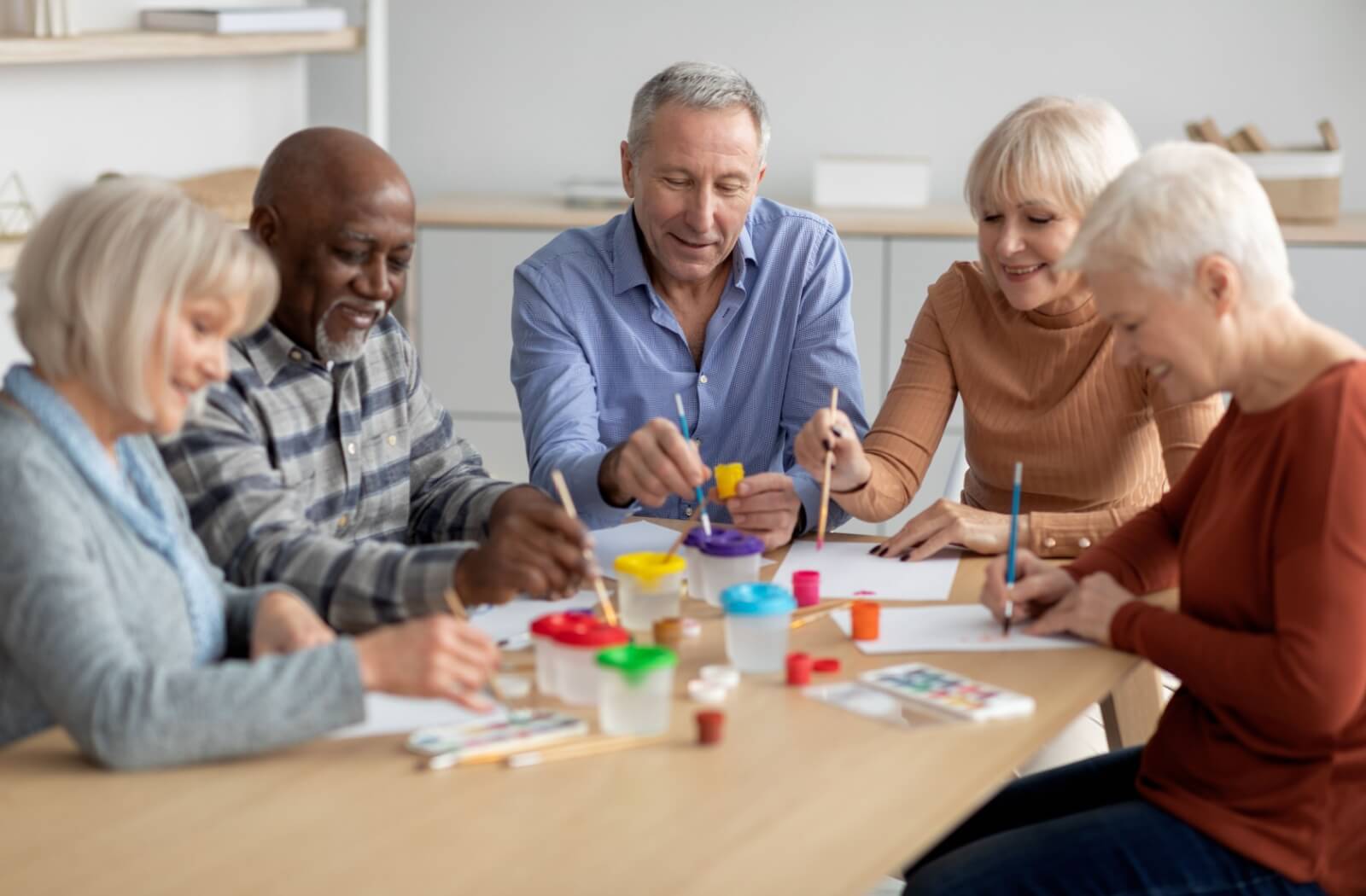 Seniors socializing and enjoying an arts and crafts activity in a senior living community