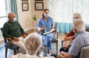 A staff member tells a group of seniors all about assisted living during a tour of the property.