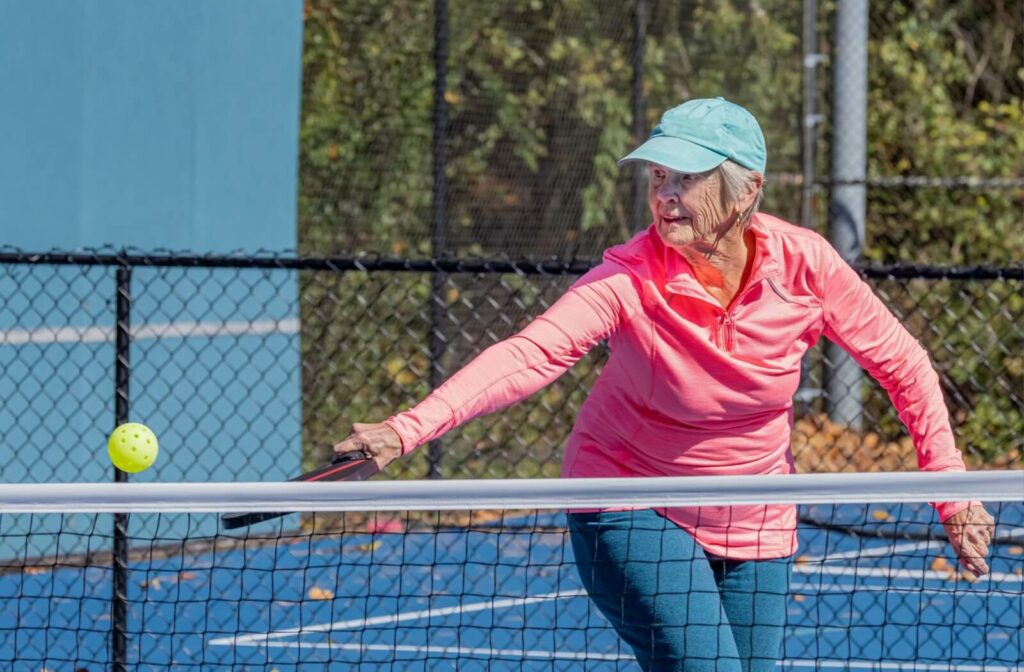 A senior playing a game of pickleball