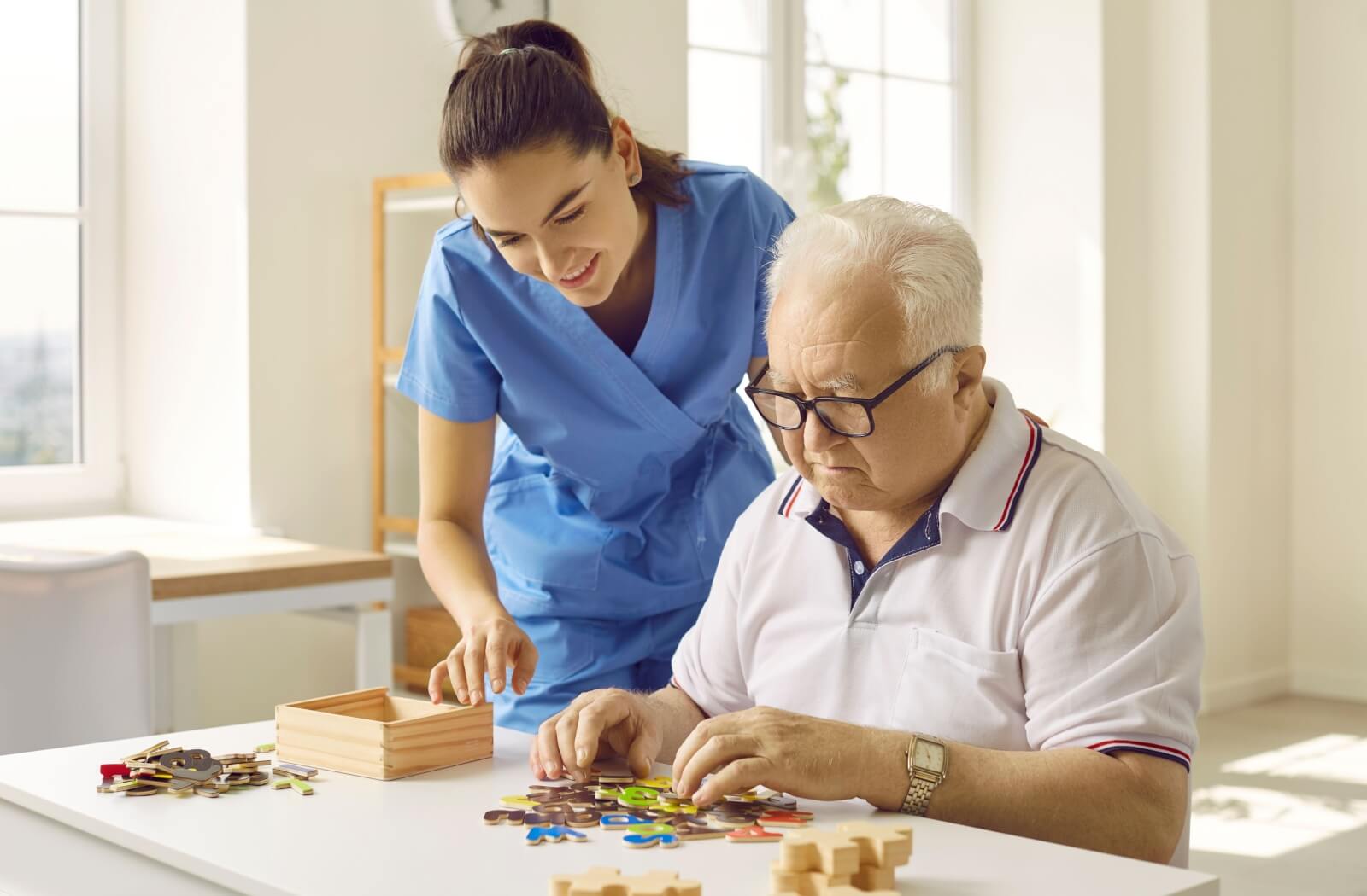 Senior uses a walker with assistance from a caretaker