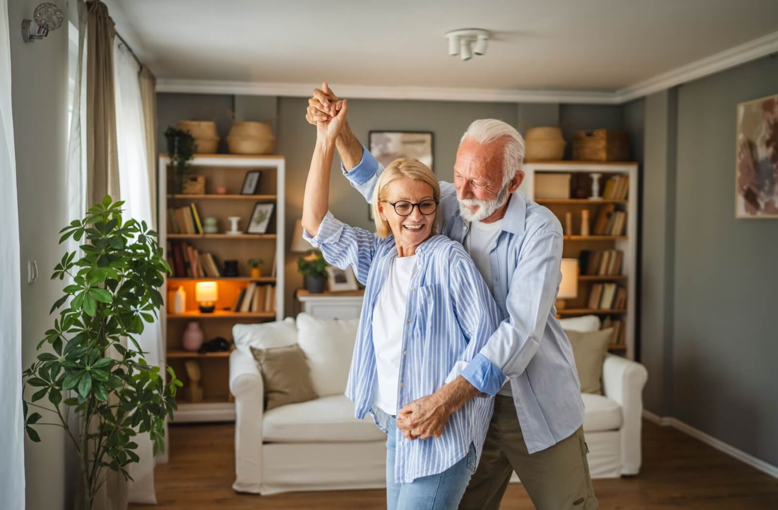 A mature, happy couple enjoys their independent living apartment.