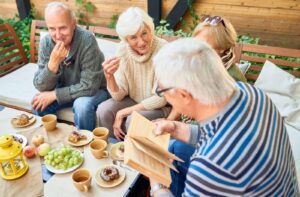 A group of friends in independent living enjoying their book club.