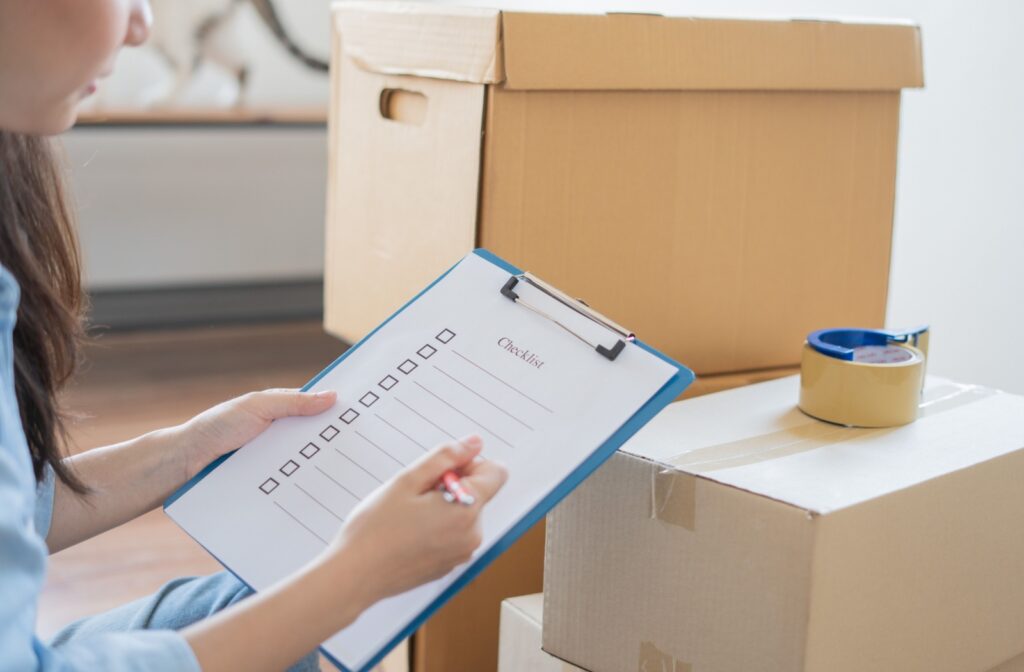 Someone is making a moving checklist for their loved one's transition into assisted living.