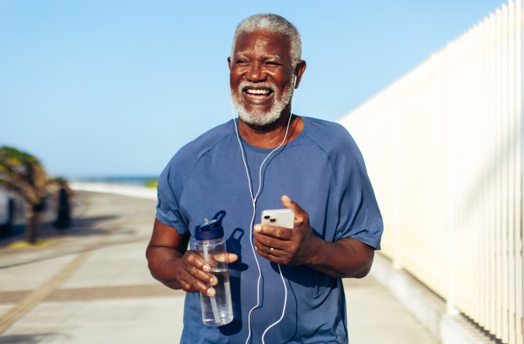 A senior person going for a walk and carrying a water bottle to stay hydrated.
