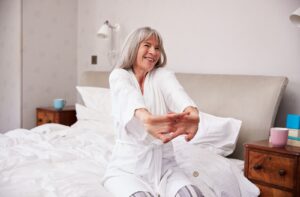 A senior wakes up in the morning feeling refreshed.