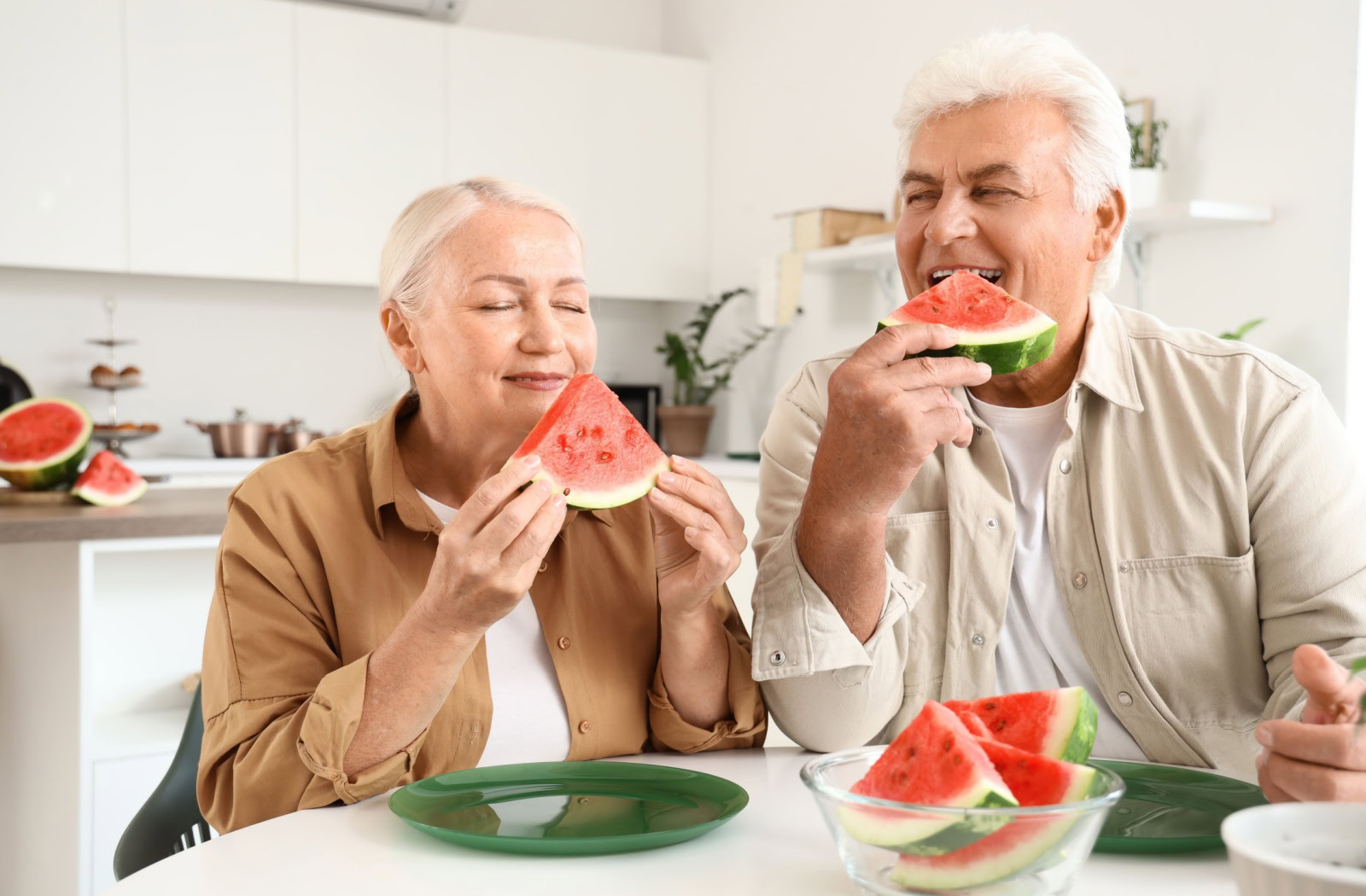 two seniors enjoy watermelon