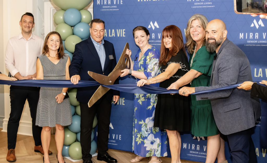 the team of mira vie at fanwood cutting a ribbon in the opening of the community
